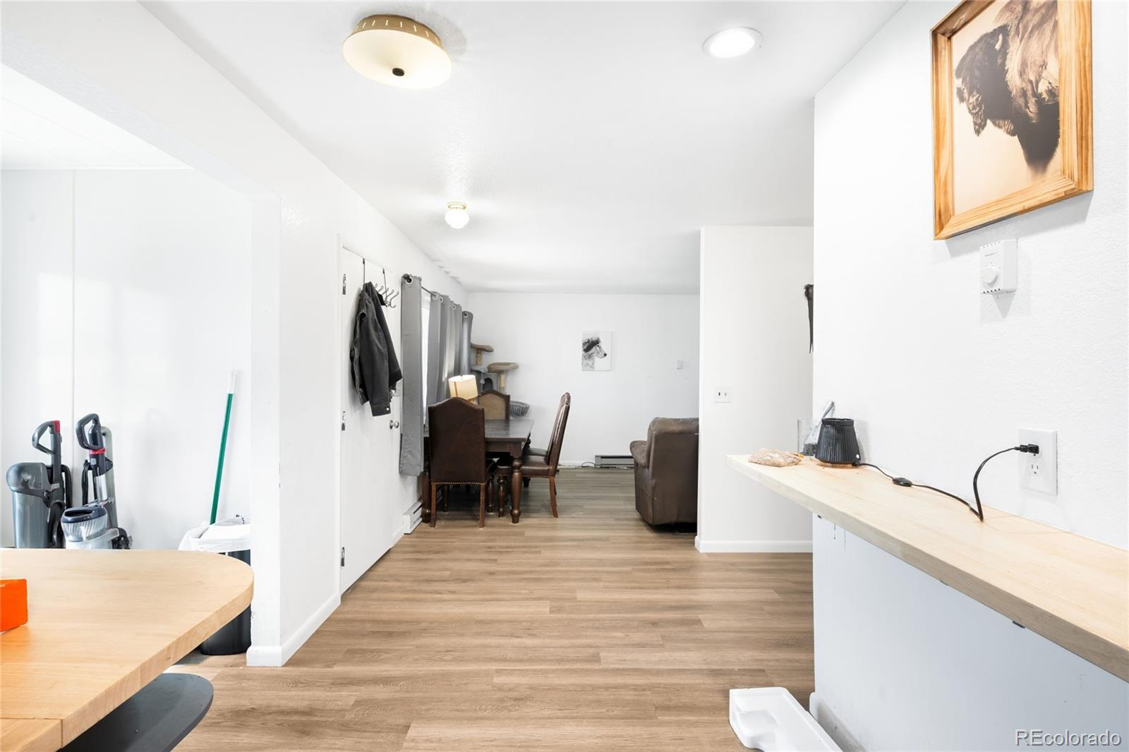 5354 Jackson Creek Road Sedalia, CO 80135 - Photo 32 of 47 a bedroom with furniture and a wooden floor