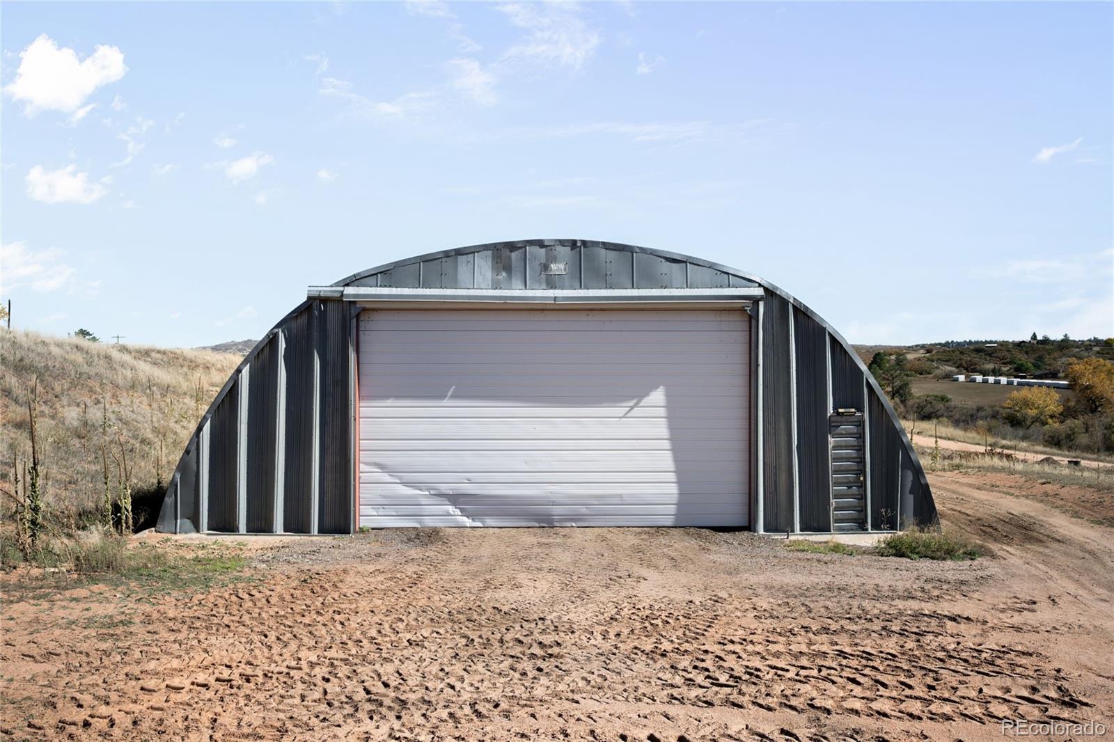 5354 Jackson Creek Road Sedalia, CO 80135 - Photo 41 of 47 a view of a house with a terrace