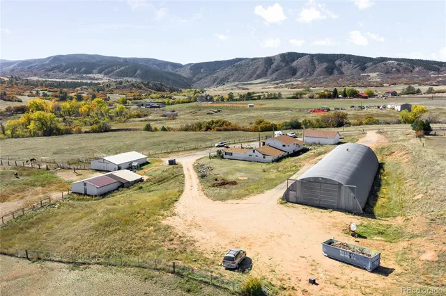 a view of a lake with a yard and large trees