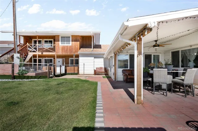 a view of a house with backyard porch and sitting area