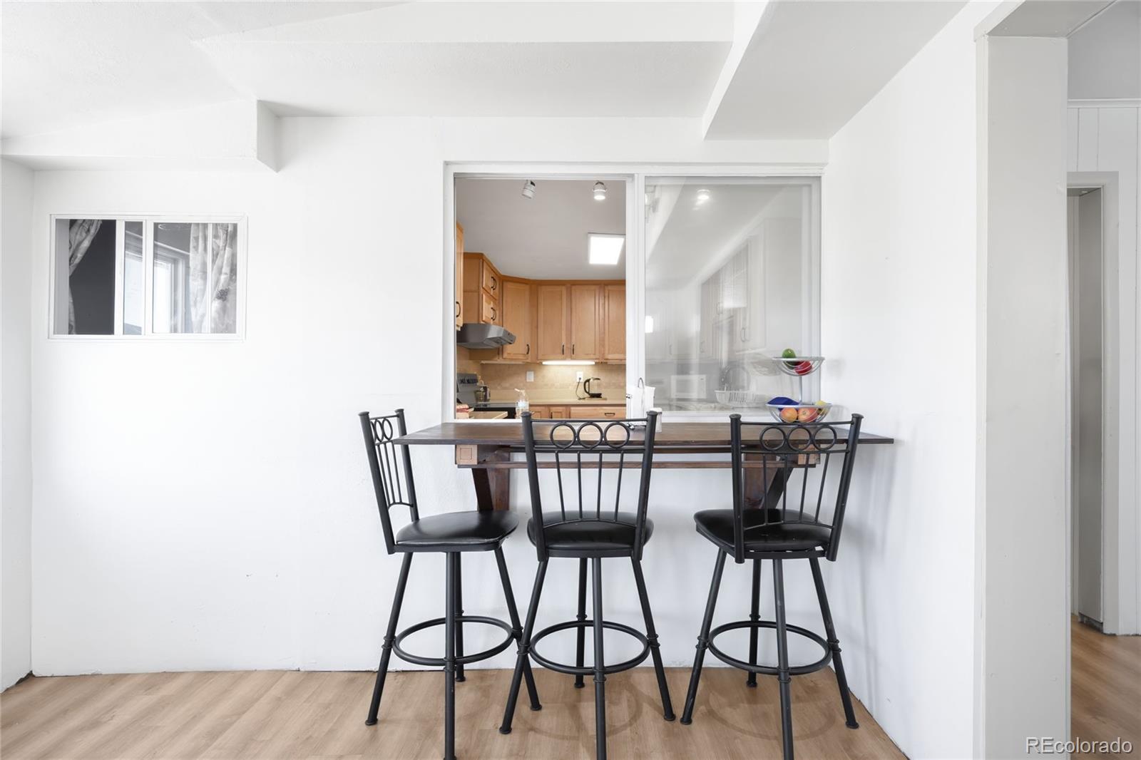 5354 Jackson Creek Road Sedalia, CO 80135 - Photo 7 of 47 a view of a dining room with furniture and wooden floor