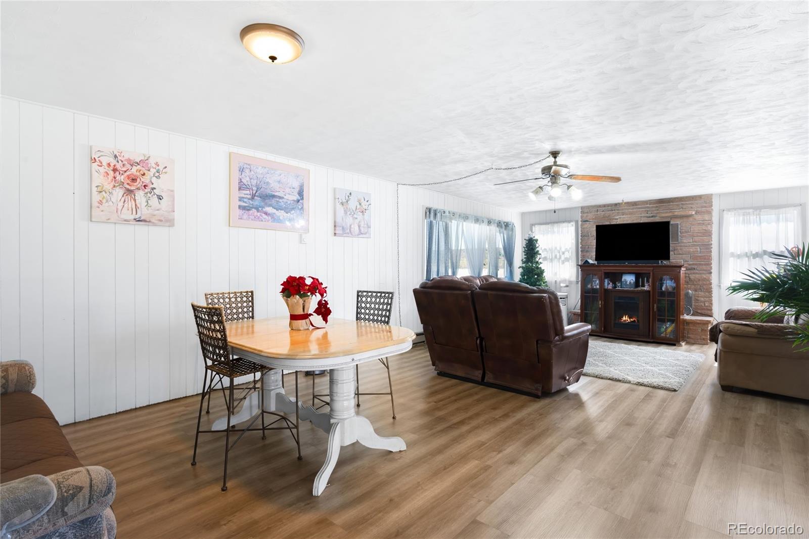 5354 Jackson Creek Road Sedalia, CO 80135 - Photo 9 of 47 a living room with furniture and a flat screen tv