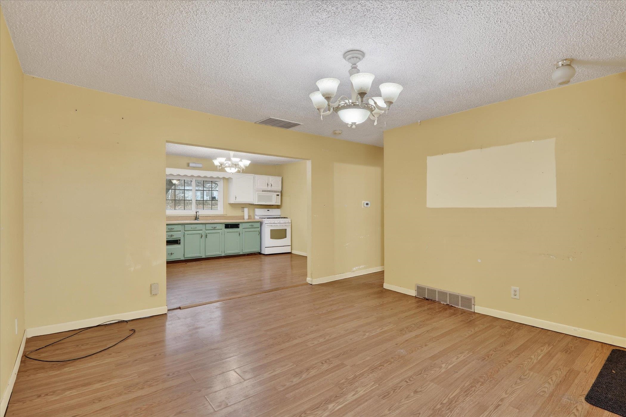 219 River Road Rochelle, IL 61068 - Photo 11 of 40 wooden floor in an empty room with a window
