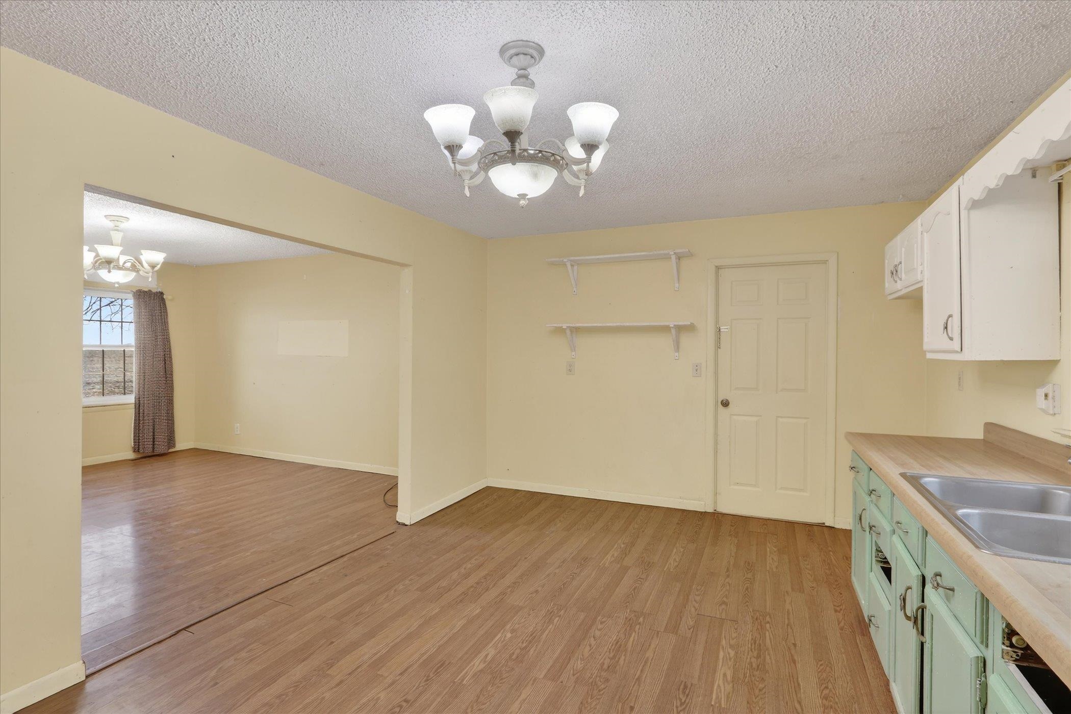 219 River Road Rochelle, IL 61068 - Photo 15 of 40 a view of a kitchen with wooden floor and a chandelier