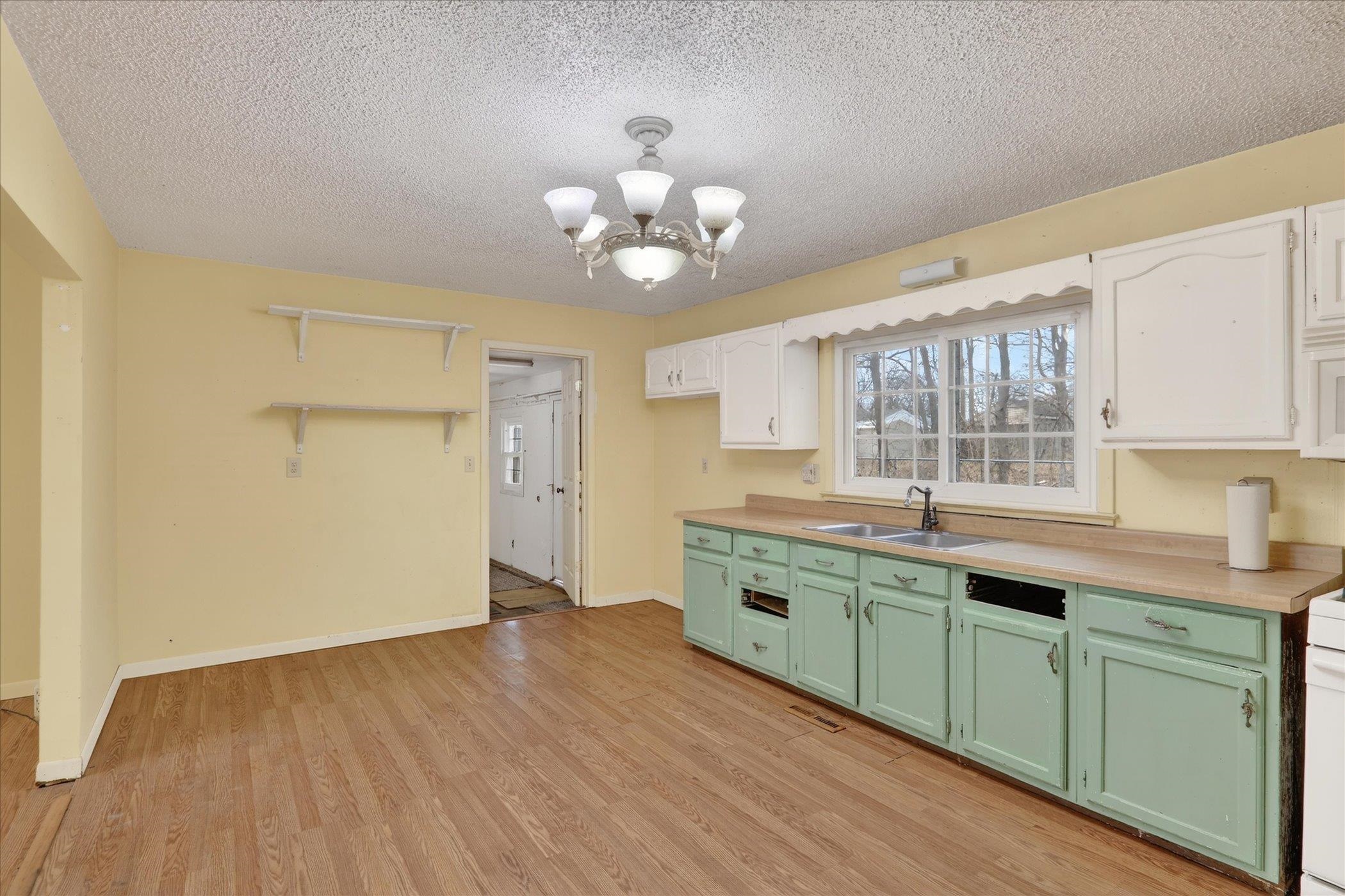 219 River Road Rochelle, IL 61068 - Photo 17 of 40 a kitchen with cabinets a sink and dishwasher