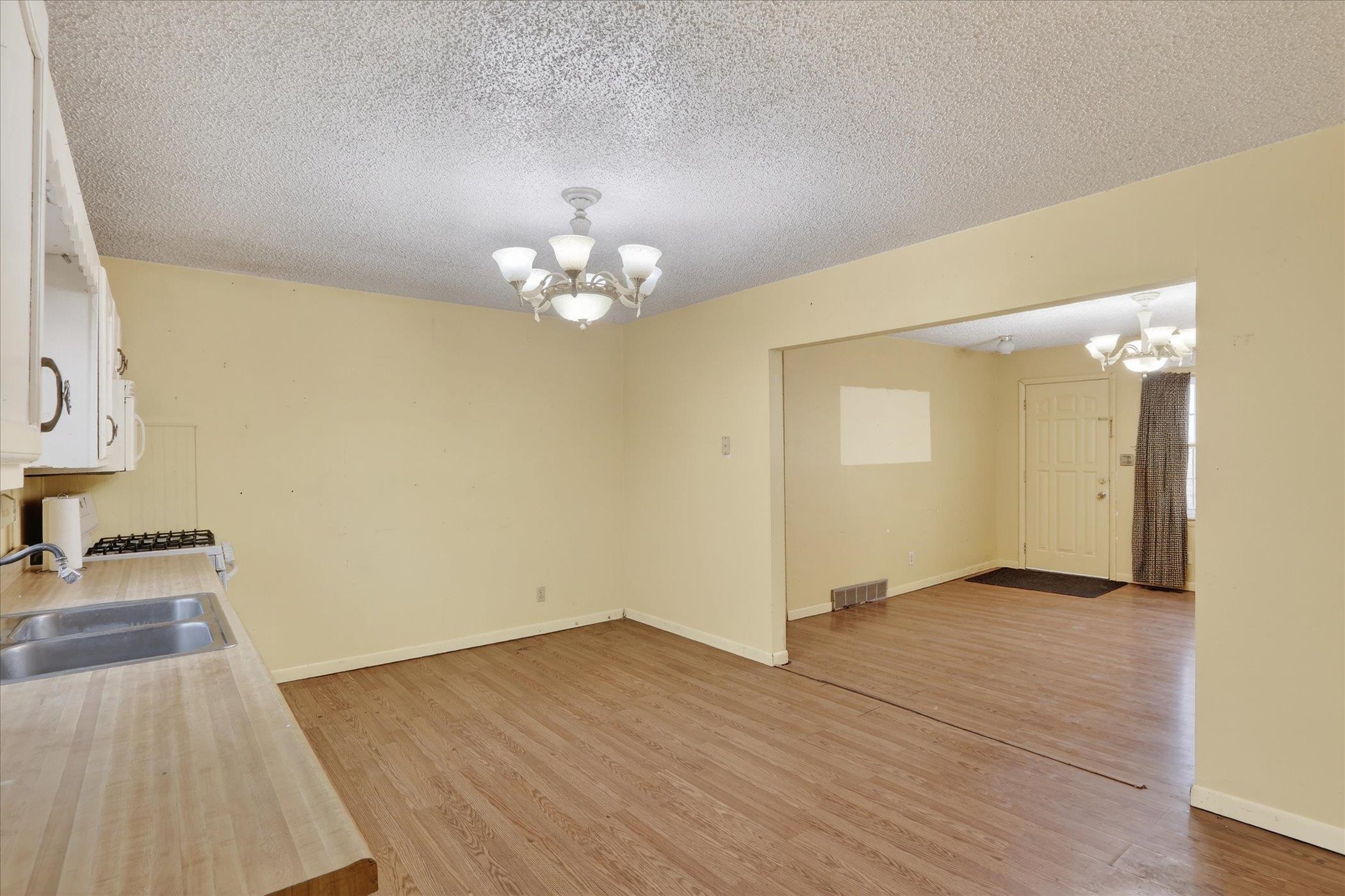 219 River Road Rochelle, IL 61068 - Photo 18 of 40 an empty room with wooden floor and mirror