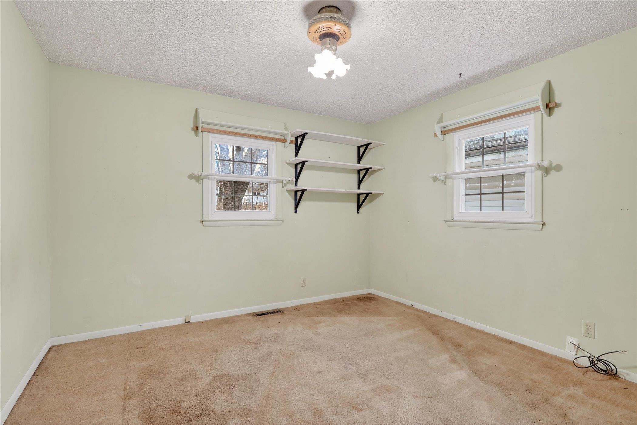 219 River Road Rochelle, IL 61068 - Photo 21 of 40 an empty room with windows and fan