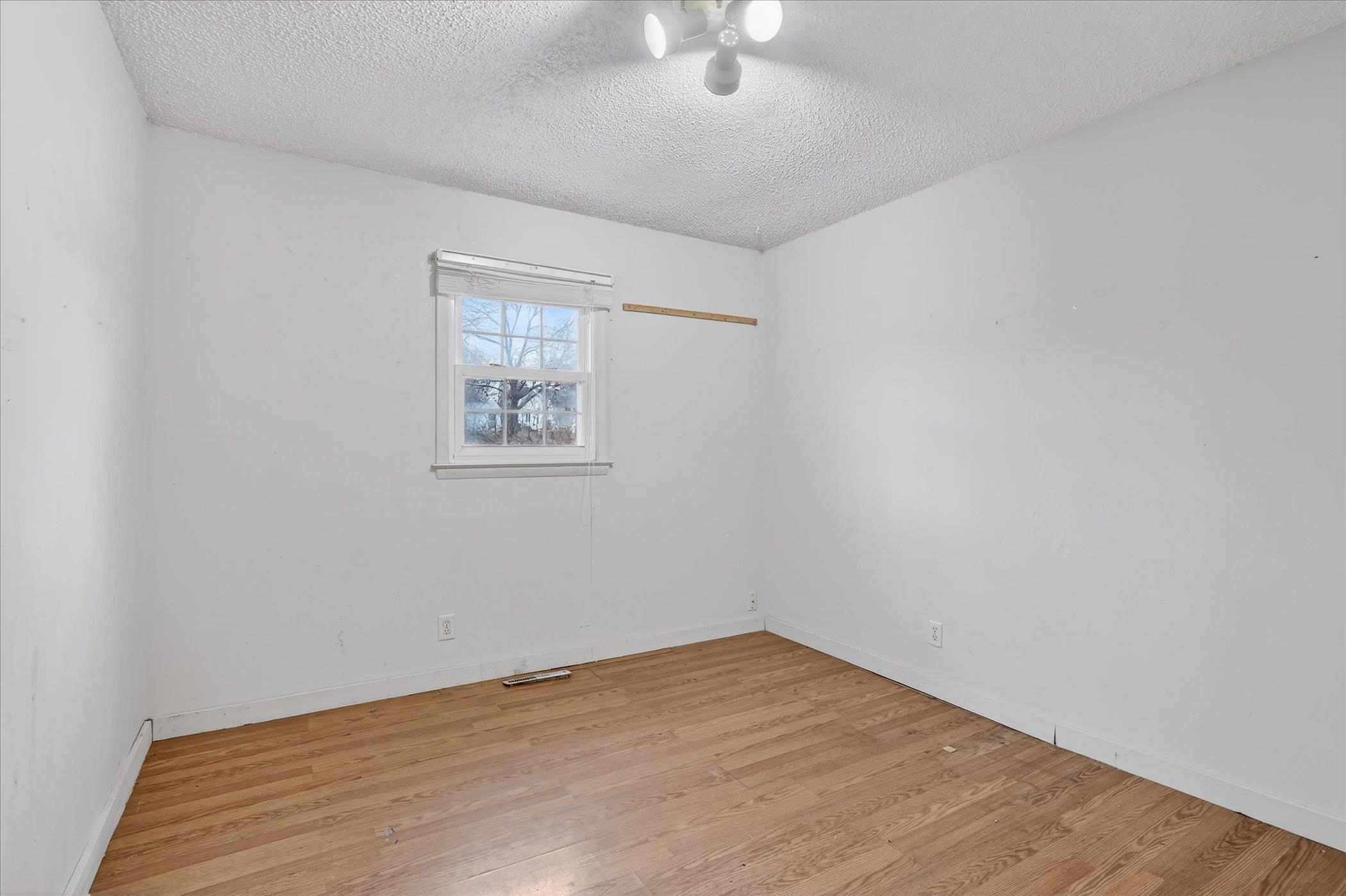 219 River Road Rochelle, IL 61068 - Photo 23 of 40 an empty room with wooden floor and windows