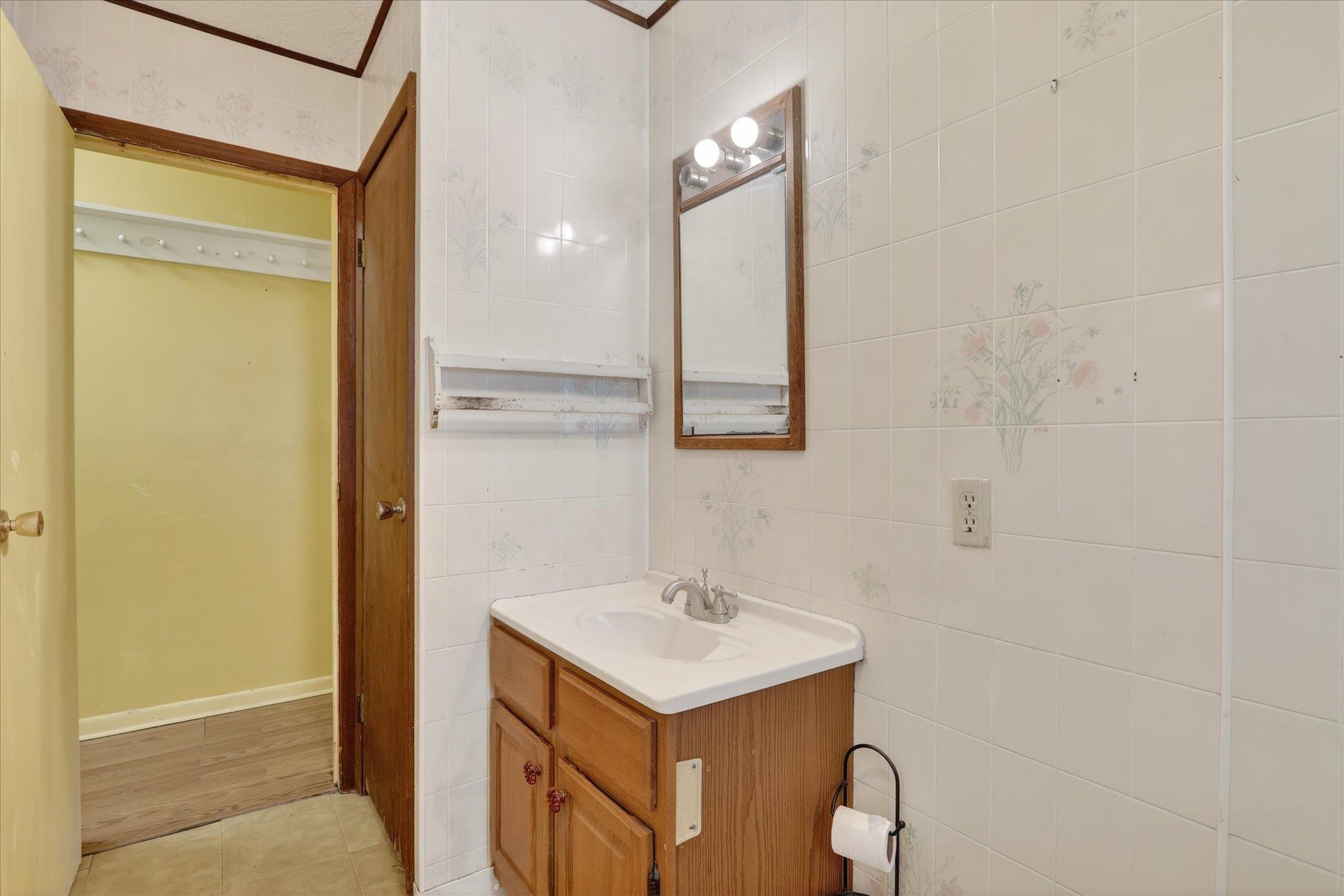 219 River Road Rochelle, IL 61068 - Photo 30 of 40 a bathroom with a sink vanity and a mirror