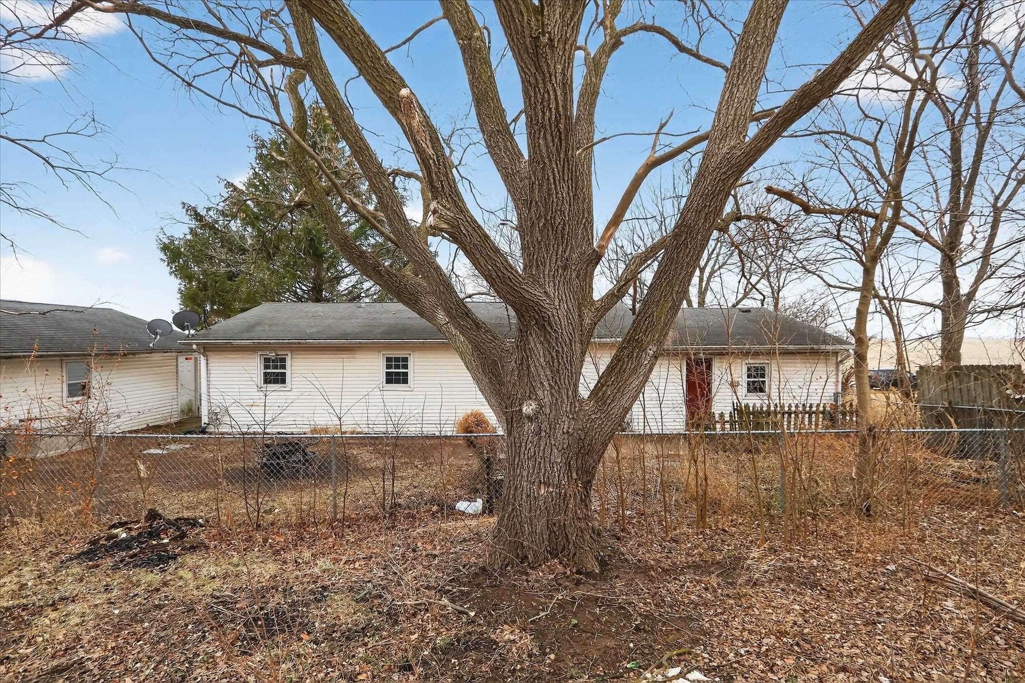 219 River Road Rochelle, IL 61068 - Photo 8 of 40 a view of a white house with a large tree