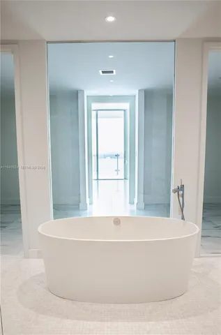 a view of a glass door with a view of living room