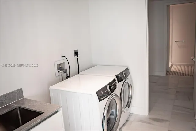 a living room with furniture and large windows