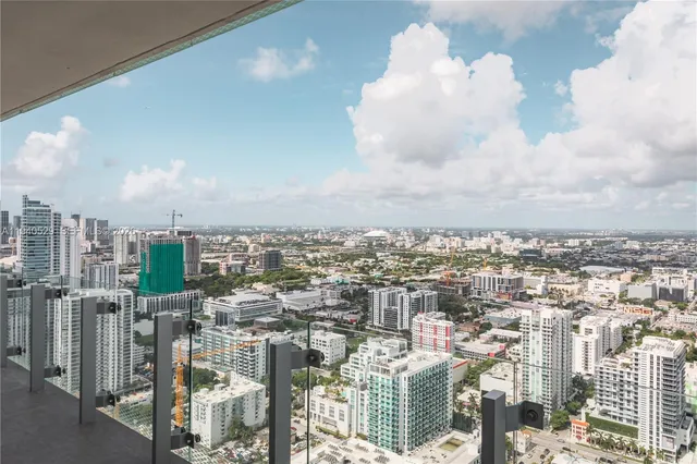 a dining room with furniture and a potted plant