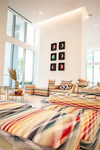 a living room filled with furniture and a large window