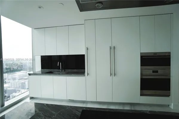 a white bath tub sitting in a en suite bathroom