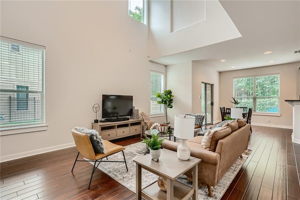 2101 Rivers Edge Way, Unit 19 Austin, TX 78741 - Photo 8 of 24 a living room with furniture a flat screen tv and wooden floor