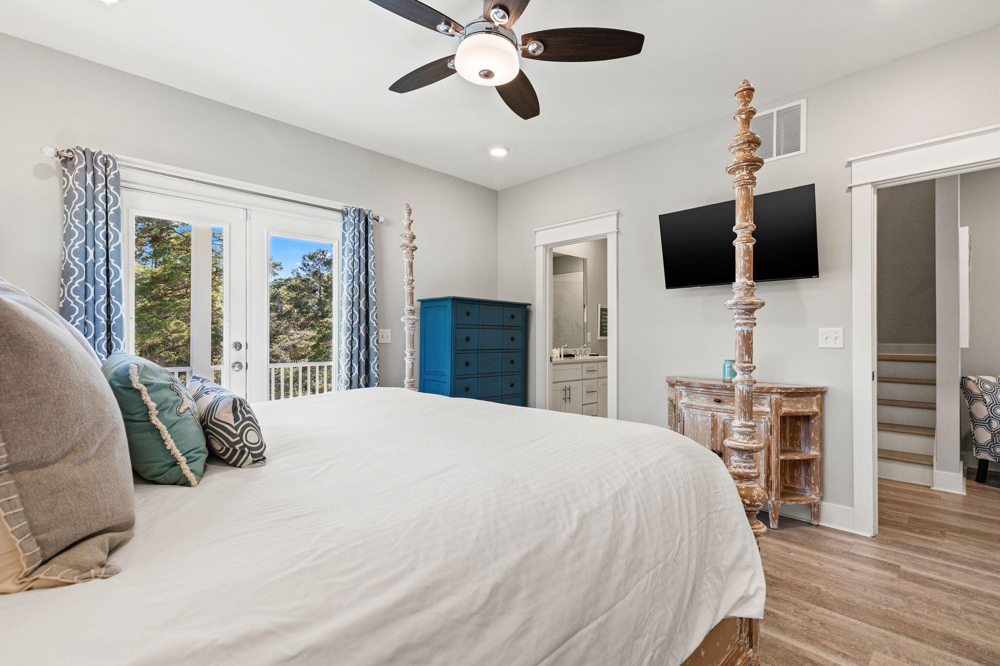 72 Magical Place Santa Rosa Beach, FL 32459 - Photo 16 of 44 a bedroom with a bed flat screen tv and a window