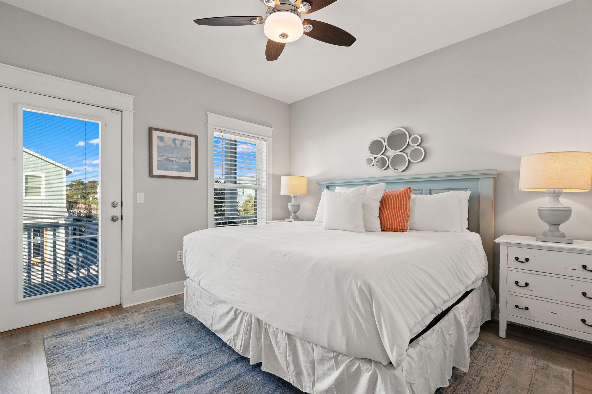 72 Magical Place Santa Rosa Beach, FL 32459 - Photo 18 of 44 a bedroom with a large bed and a chandelier