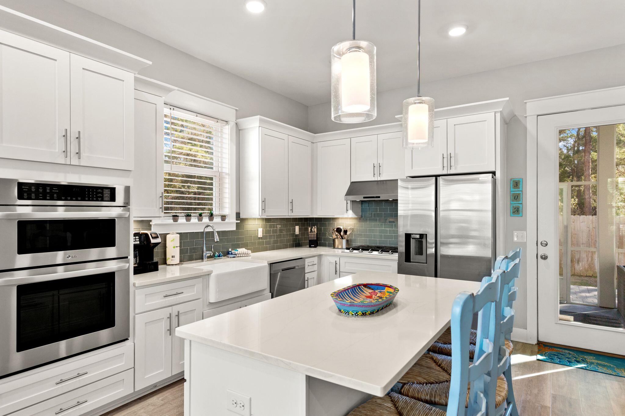 72 Magical Place Santa Rosa Beach, FL 32459 - Photo 6 of 44 a kitchen with refrigerator a stove and a wooden floor