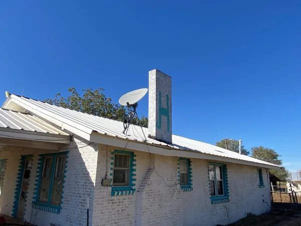 a roof deck with table and chairs