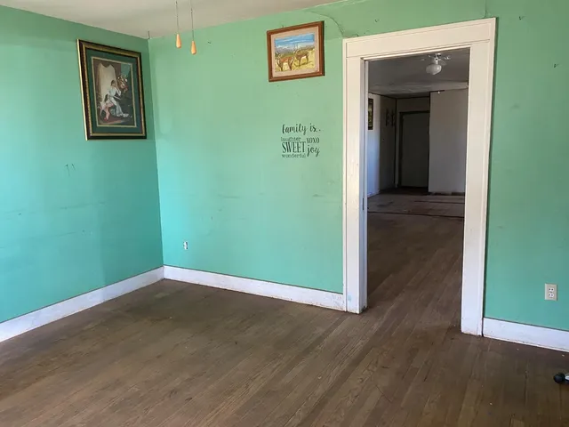 an empty room with wooden floor and closet