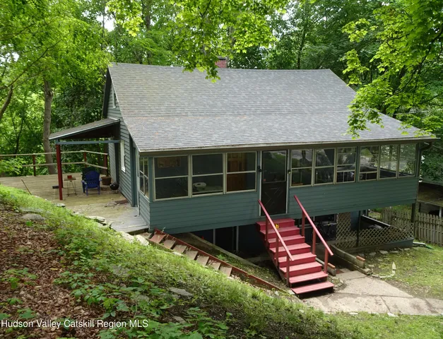 a aerial view of a house with a yard table and chairs