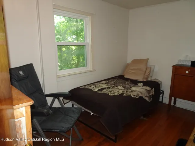 a bed sitting in a bedroom next to a window