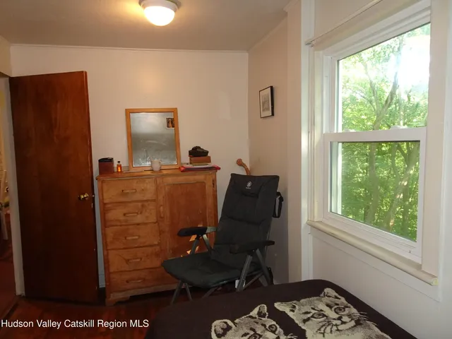 a room with a dresser and a window
