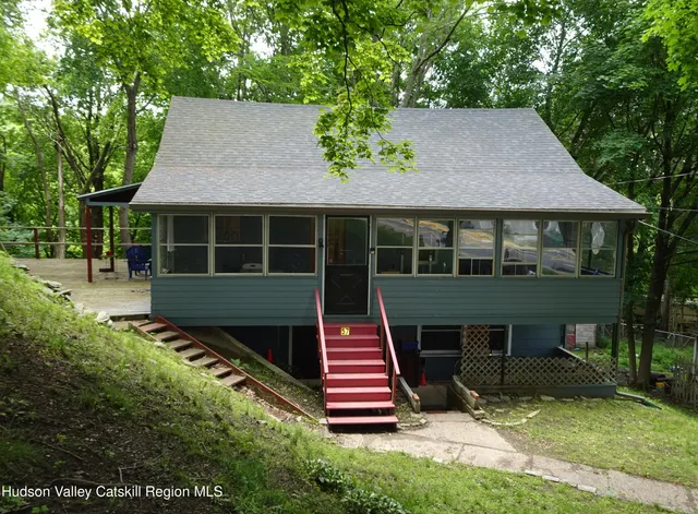 a front view of a house with a garden