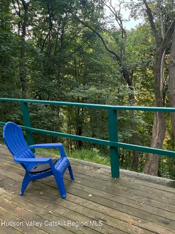 a wooden bench sitting in front of a tree