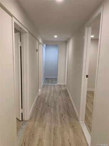 a view of hallway with wooden floor