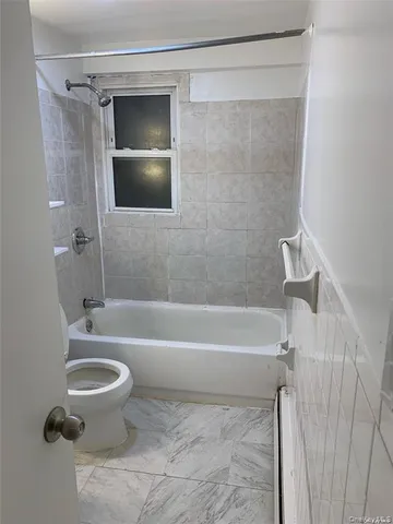 a bathroom with a toilet a sink and bathtub