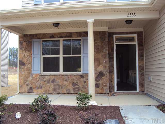 2333 Everstone Road Wake Forest, NC 27587 - Photo 2 of 20 Front porch is ready for rockers or your favorite bistro set! Enhanced with beautiful stone detail!