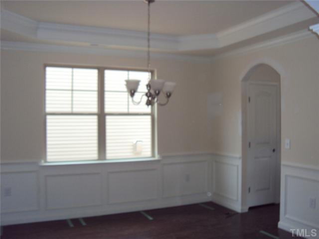 2333 Everstone Road Wake Forest, NC 27587 - Photo 5 of 20 Arched entry and passageway along with the trey ceiling and wood trim detail really formalize this DR!