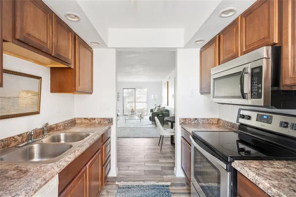 a kitchen with a sink stove top oven and microwave
