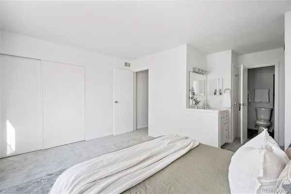 a bedroom with a bed and hallway
