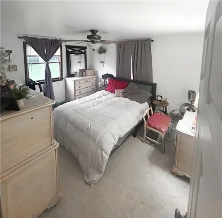 a bed room with a bed and a chair