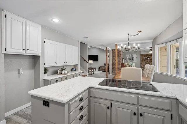 a kitchen with a stove refrigerator and cabinets