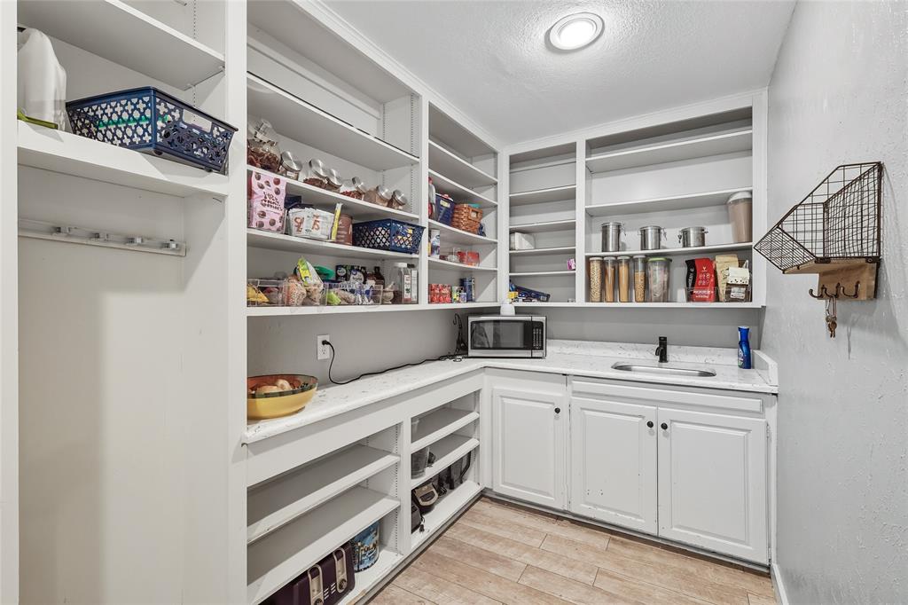 2908 Steve Drive Hurst, TX 76054 - Photo 21 of 40 a kitchen with a sink and cabinets