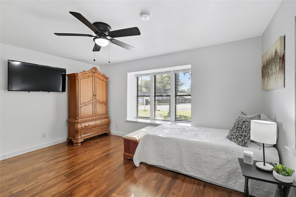 2908 Steve Drive Hurst, TX 76054 - Photo 28 of 40 a bedroom with a bed and a flat screen tv