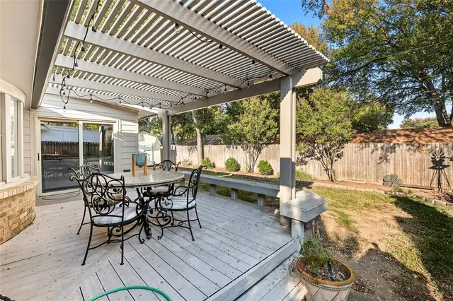 a view of a patio with table and chairs and wooden floor