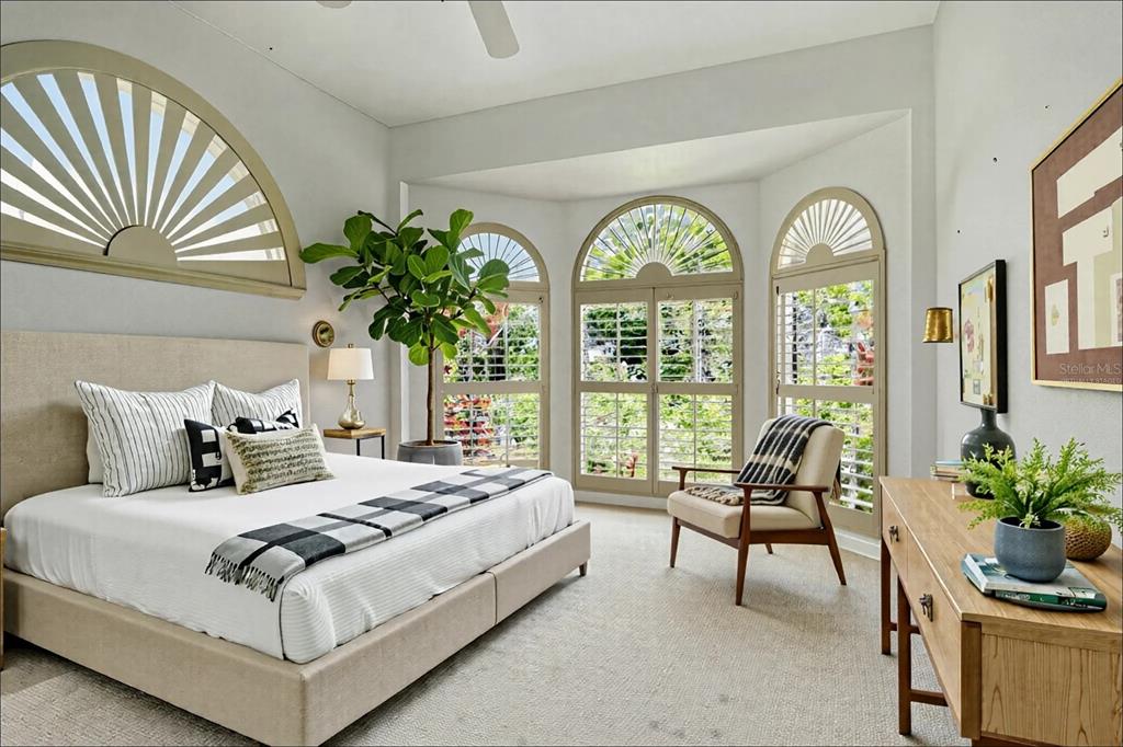 340 Bermuda Court, Unit 5 Venice, FL 34293 - Photo 26 of 52 a bedroom with bed and a large window