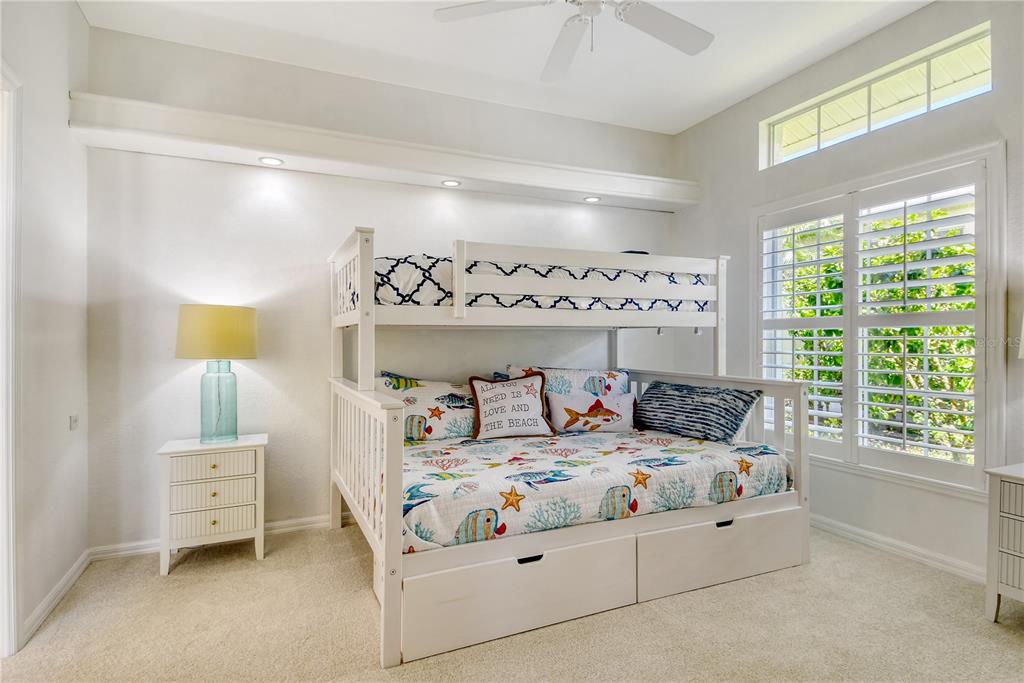 340 Bermuda Court, Unit 5 Venice, FL 34293 - Photo 28 of 52 a bedroom with a bed and a window