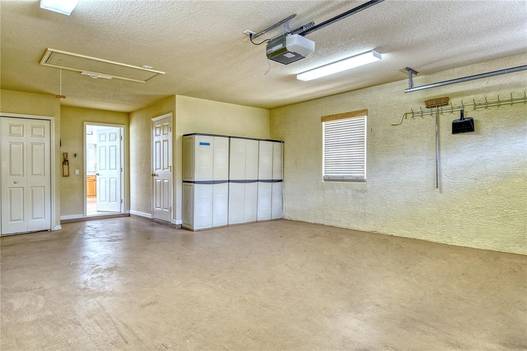 340 Bermuda Court, Unit 5 Venice, FL 34293 - Photo 32 of 52 an empty room with windows and a chandelier