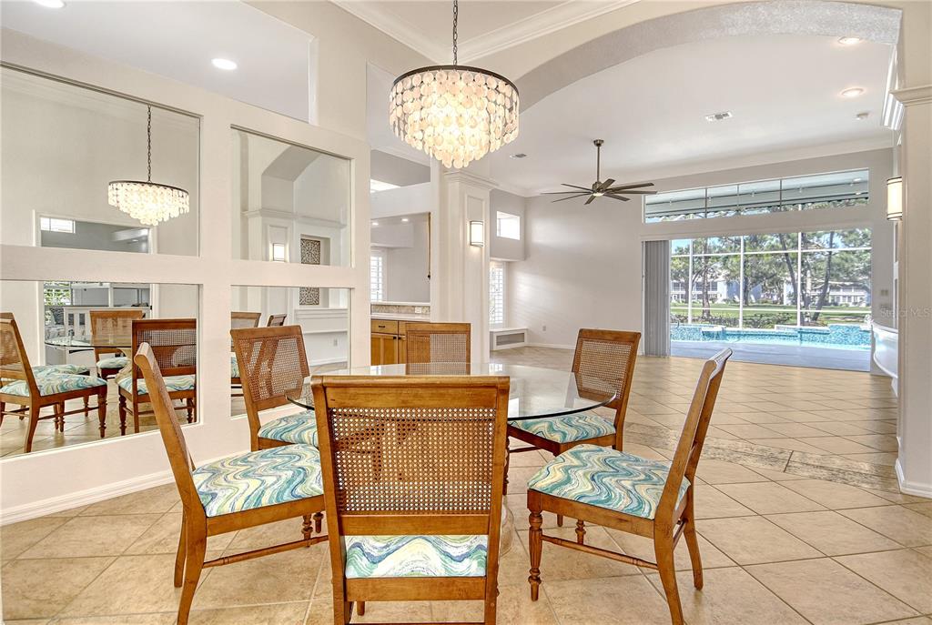 340 Bermuda Court, Unit 5 Venice, FL 34293 - Photo 7 of 52 a view of a dining room with furniture and chandelier