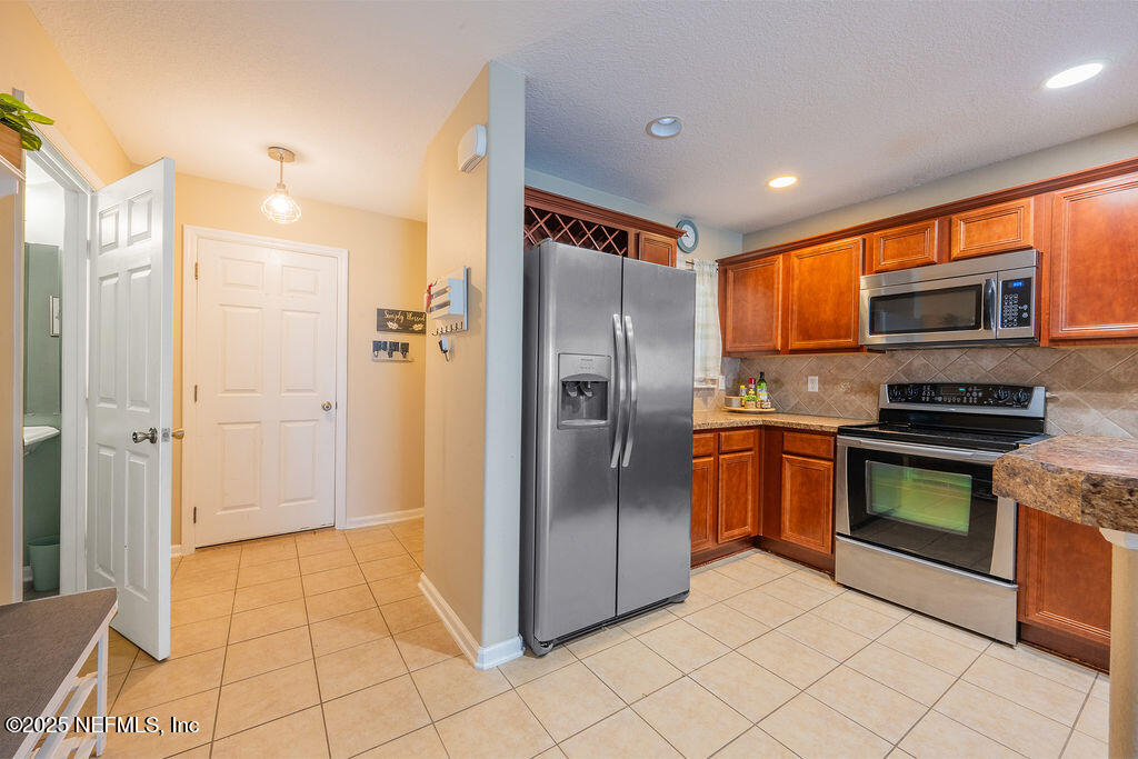 160 Crete Court St. Augustine, FL 32084 - Photo 12 of 33 a kitchen with stainless steel appliances granite countertop a refrigerator and a sink