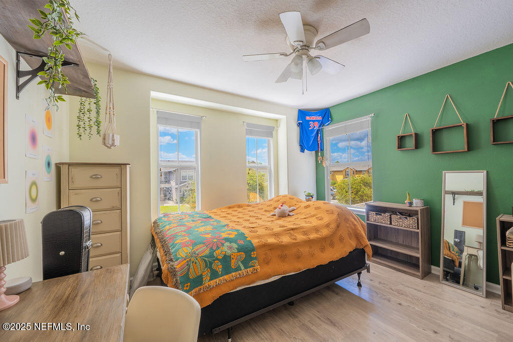 160 Crete Court St. Augustine, FL 32084 - Photo 19 of 33 a bedroom with a bed and a chandelier