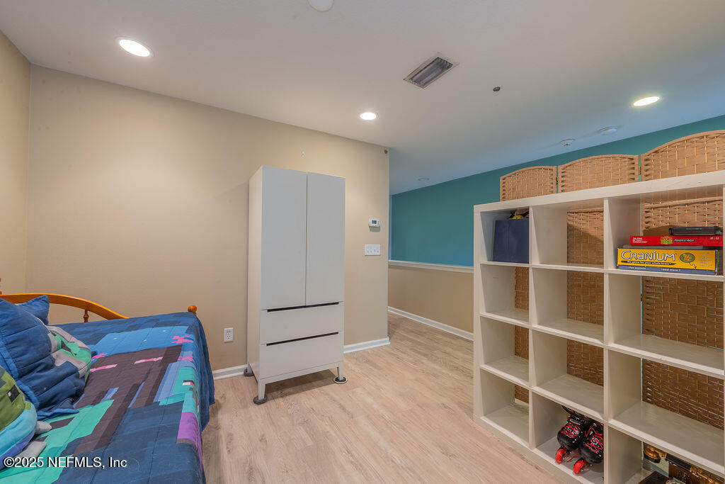 160 Crete Court St. Augustine, FL 32084 - Photo 24 of 33 a bed room with a bed and a book shelf