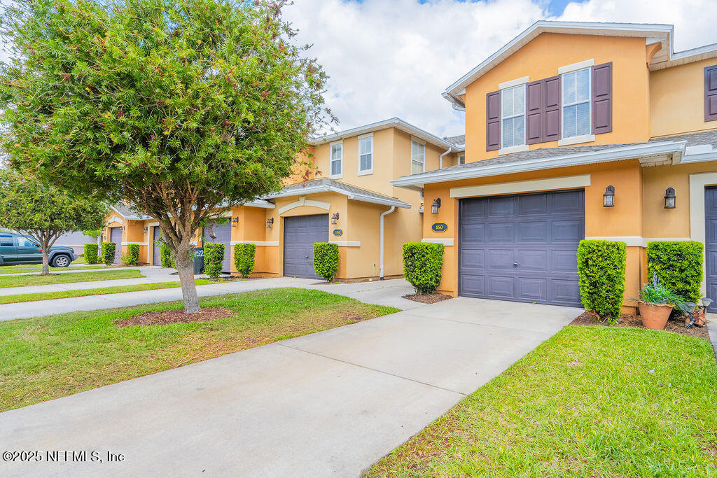 160 Crete Court St. Augustine, FL 32084 - Photo 27 of 33 a front view of a house with a yard and trees