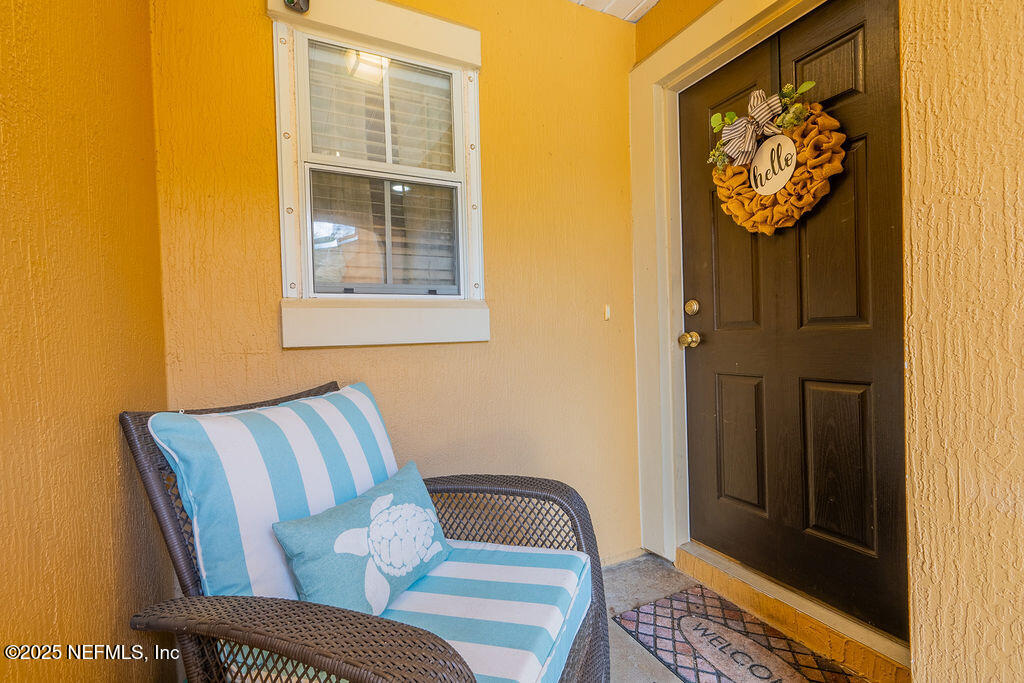 160 Crete Court St. Augustine, FL 32084 - Photo 3 of 33 a view of a hallway with wooden floor and chair
